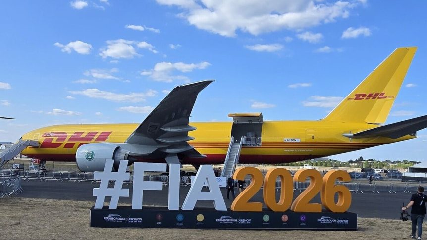 DHL Boeing 777 freighter behind the #FIA2026 sign at Farnborough Airshow 2026 (or the Fursan alt from earlier if you use that one).